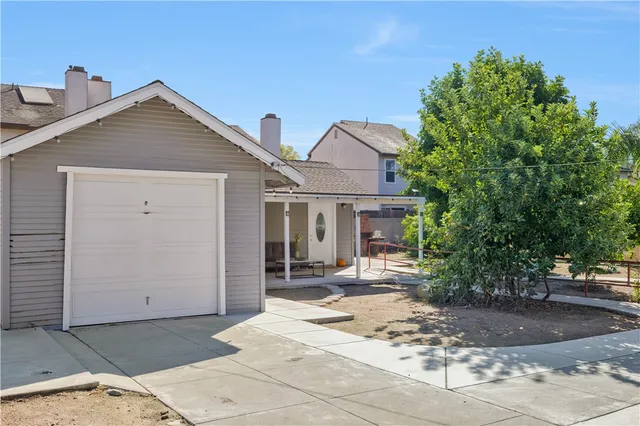 a view of a house with sitting area and garden