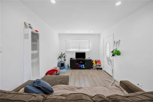 a kitchen with stainless steel appliances a white table and chairs in it