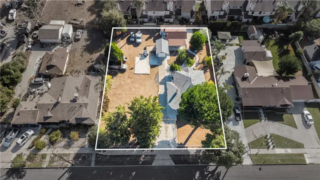 an aerial view of residential house with outdoor space and parking