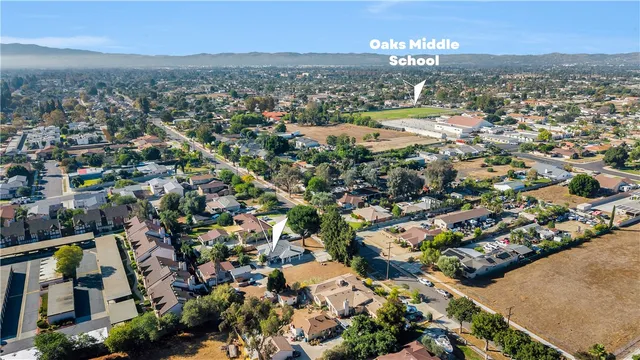 an aerial view of residential house and sandy dunes