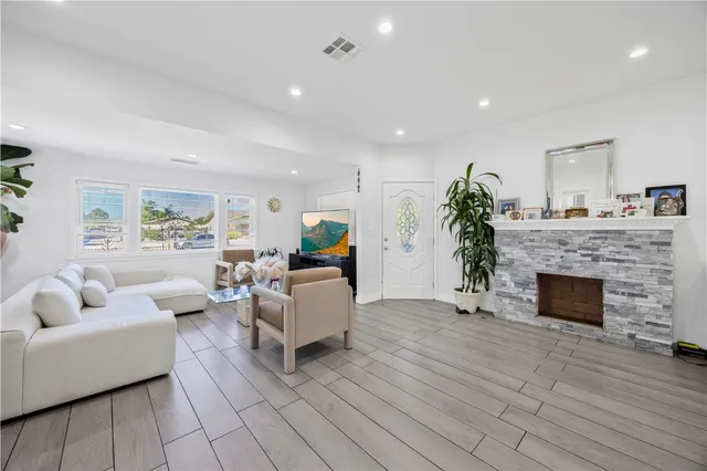 a living room with furniture and a fireplace