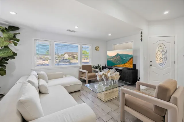 a living room with furniture and a large window