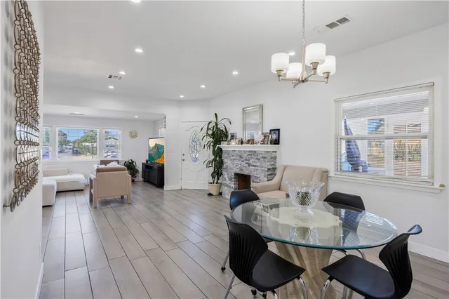 a living room with fireplace furniture and a chandelier