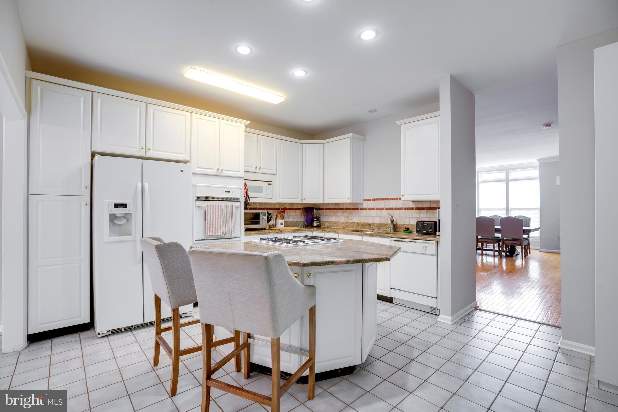 5909 Rinard Drive Centreville, VA 20120 - Photo 13 of 46 a kitchen with stainless steel appliances a table and chairs in it