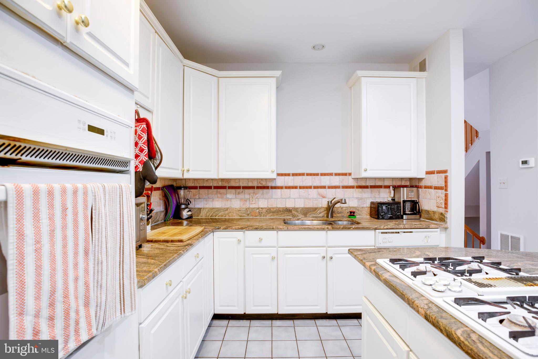 5909 Rinard Drive Centreville, VA 20120 - Photo 15 of 46 a kitchen with stainless steel appliances granite countertop a stove and a sink