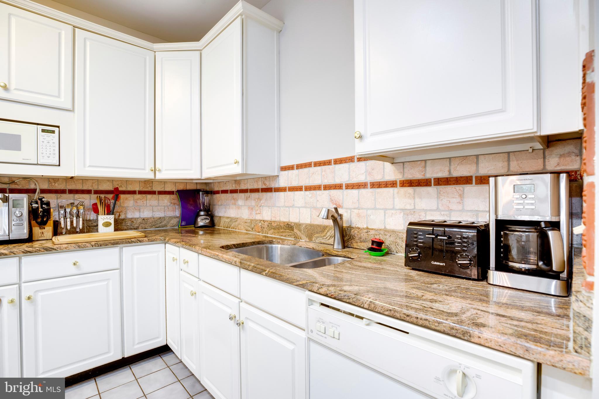 5909 Rinard Drive Centreville, VA 20120 - Photo 17 of 46 a kitchen with stainless steel appliances granite countertop a sink and cabinets