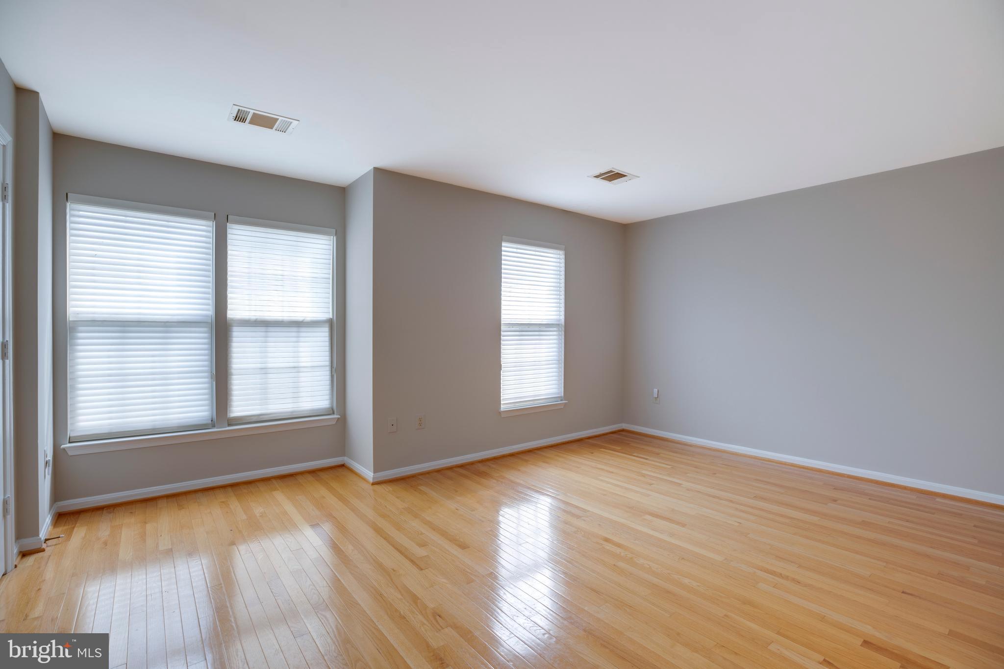 5909 Rinard Drive Centreville, VA 20120 - Photo 33 of 46 an empty room with wooden floor and windows