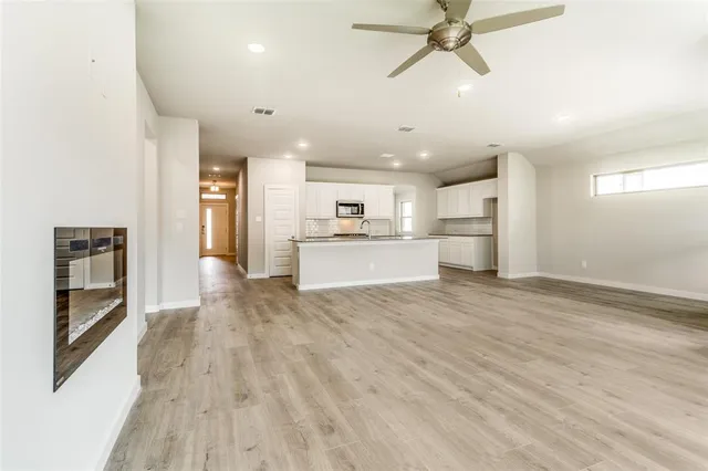 a view of a kitchen with a sink and a refrigerator
