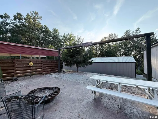 a view of a yard with plants and trees
