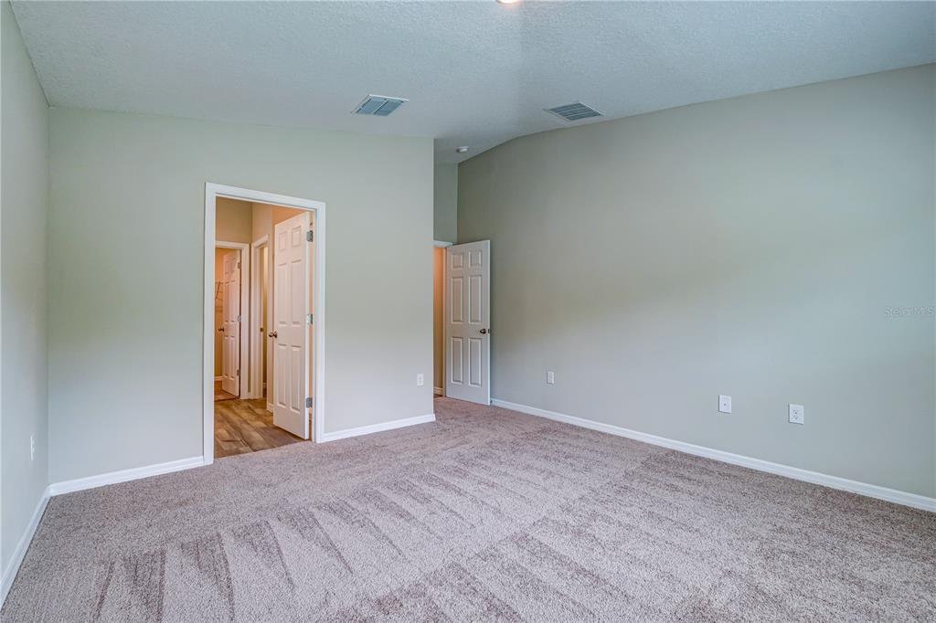 12730 Hysmith Loop Parrish, FL 34219 - Photo 13 of 33 a view of a big room with closet and wooden floor