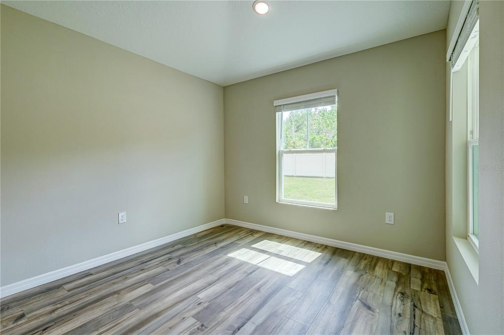 12730 Hysmith Loop Parrish, FL 34219 - Photo 17 of 33 a view of empty room with wooden floor and fan