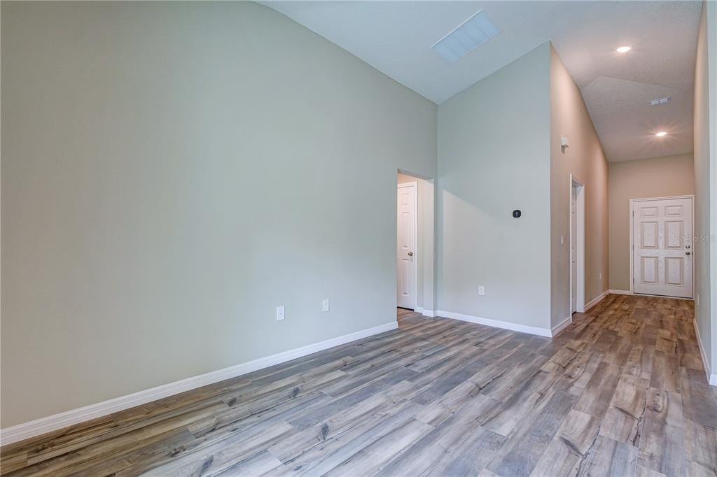 12730 Hysmith Loop Parrish, FL 34219 - Photo 3 of 33 a view of hallway with wooden floor