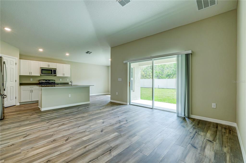 12730 Hysmith Loop Parrish, FL 34219 - Photo 5 of 33 a view of a kitchen with wooden floor and a sink