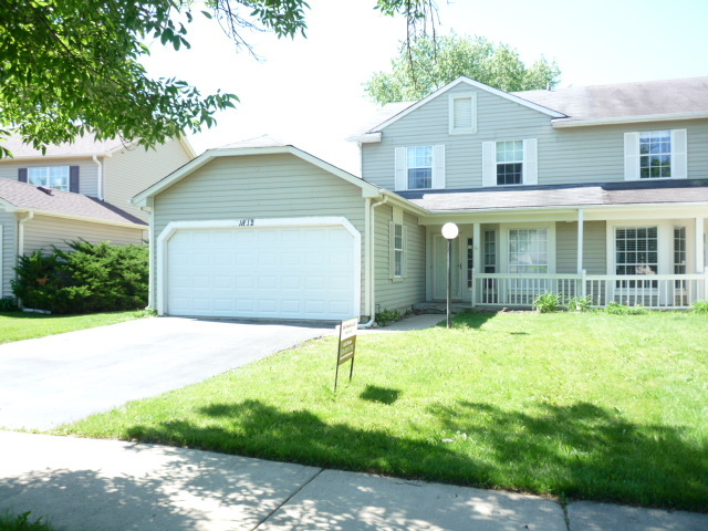 1812 77th Street Naperville, IL 60565 - Photo 1 of 17 a front view of a house with a garden and garage