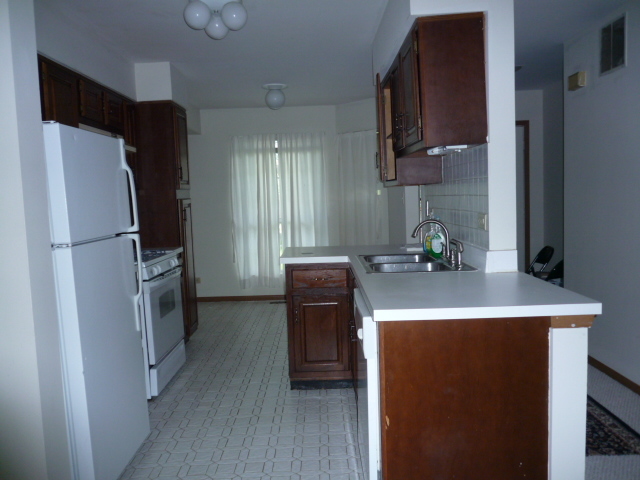 1812 77th Street Naperville, IL 60565 - Photo 2 of 17 a kitchen with a sink a refrigerator and a stove