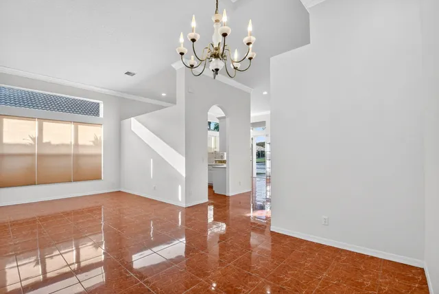 a view of a house with a yard and potted plants