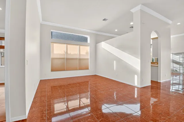 a view of a house with a large window and wooden fence
