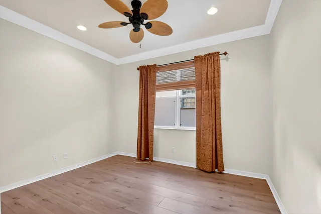 a view of a dining room with furniture a chandelier and window
