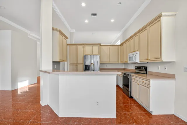 a kitchen with stainless steel appliances granite countertop a sink a stove and a refrigerator