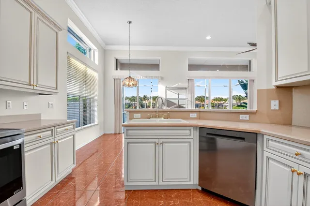 an empty room with wooden floor ceiling fan and windows