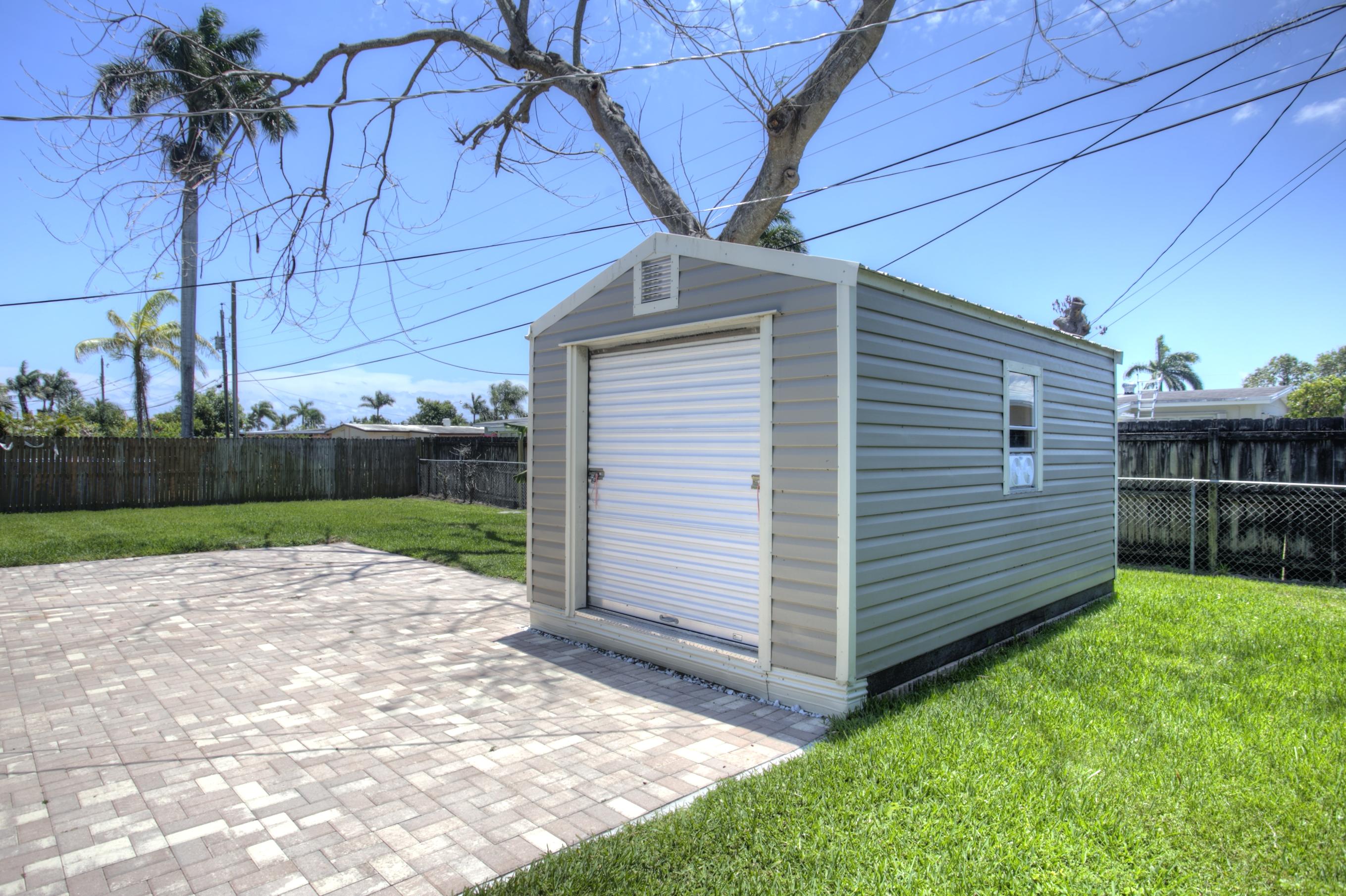 353 Shady Lane Road Palm Springs, FL 33461 - Photo 11 of 30 a view of a backyard with a garden