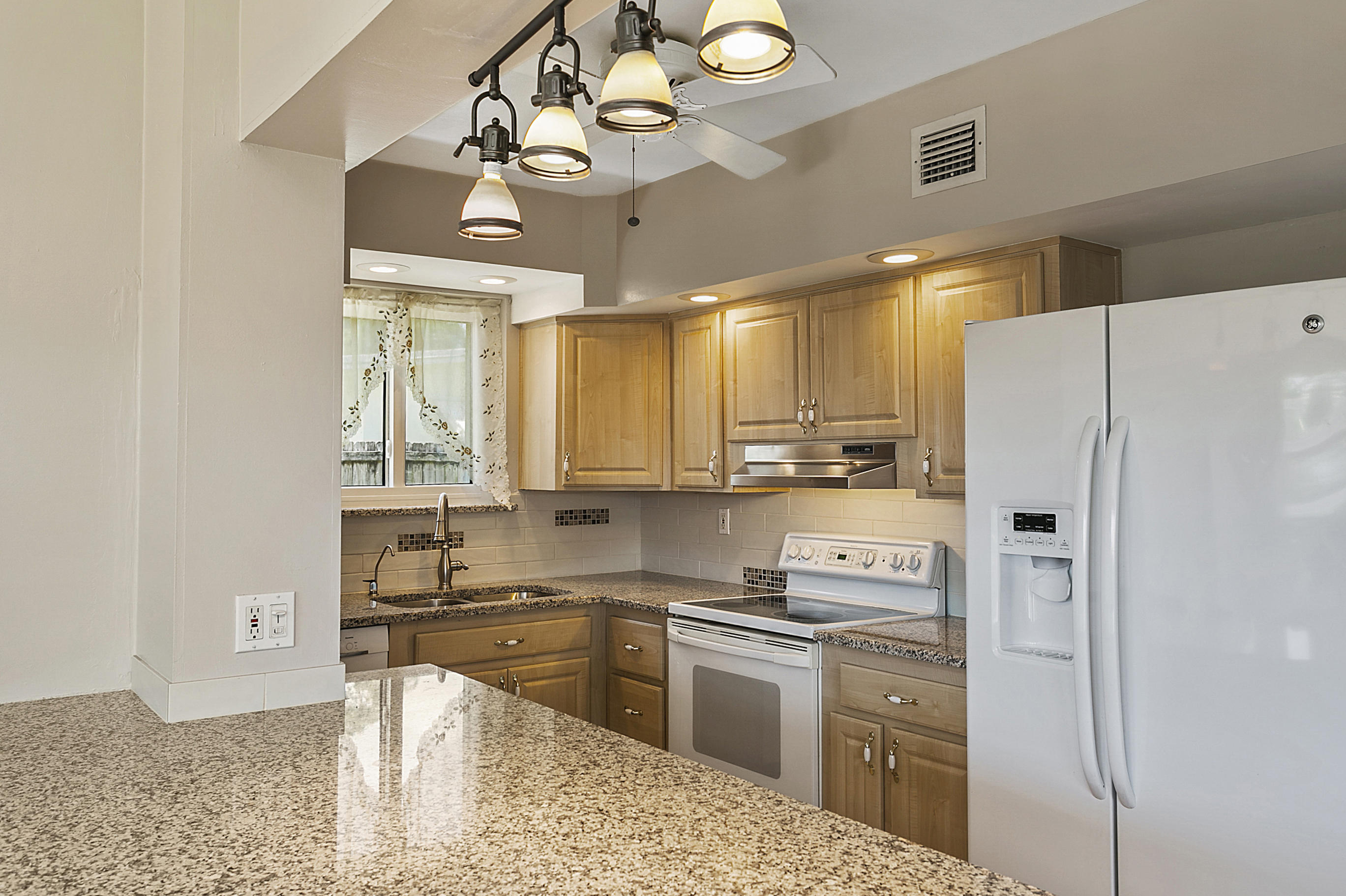 353 Shady Lane Road Palm Springs, FL 33461 - Photo 16 of 30 a kitchen with a refrigerator a sink and dishwasher with a dining table