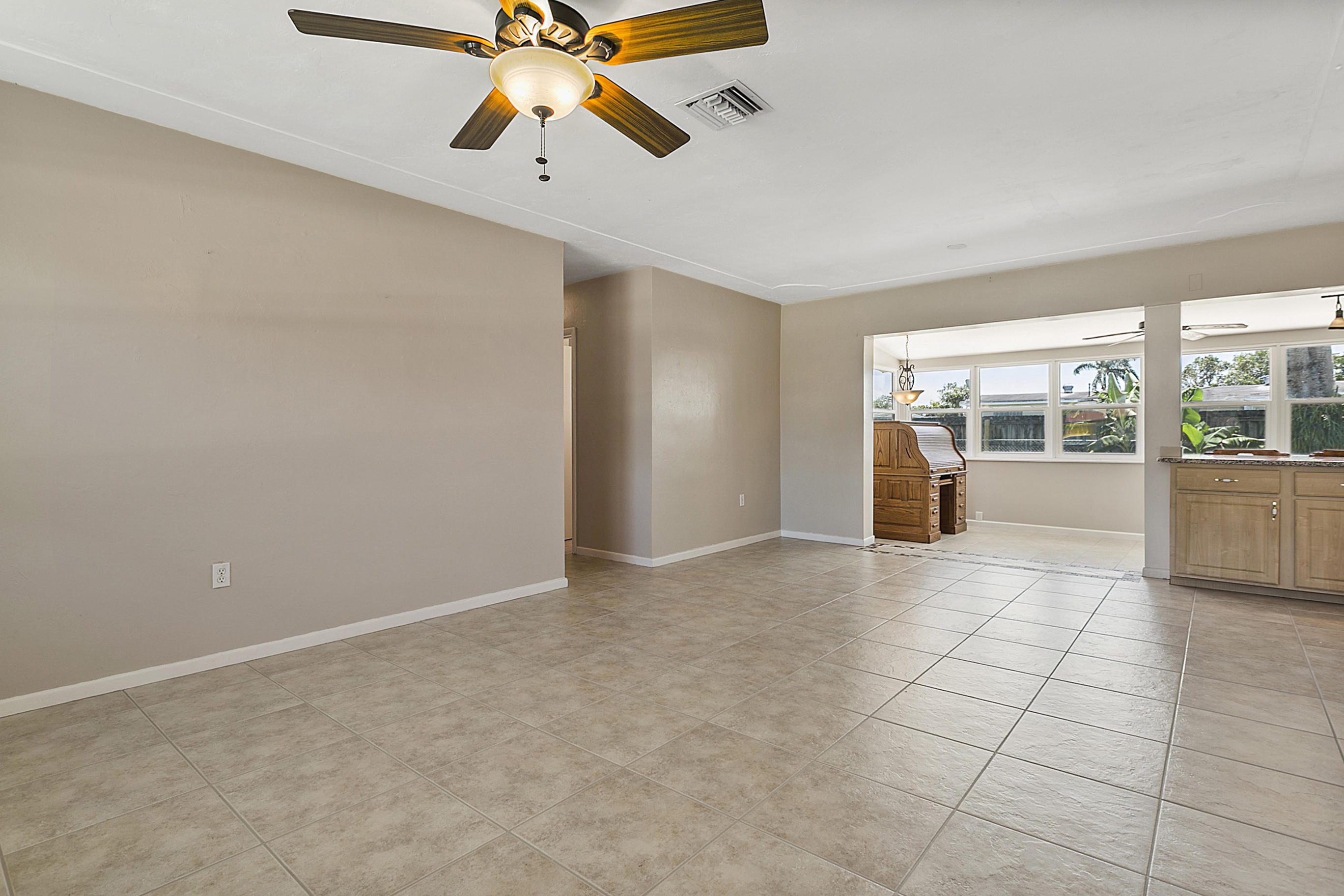 353 Shady Lane Road Palm Springs, FL 33461 - Photo 2 of 30 a view of an empty room and window