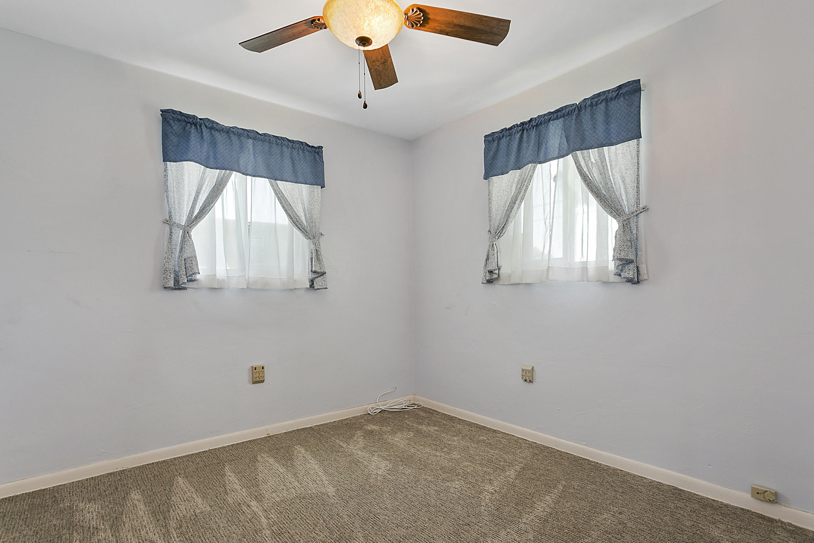 353 Shady Lane Road Palm Springs, FL 33461 - Photo 21 of 30 an empty room with wooden floor and windows