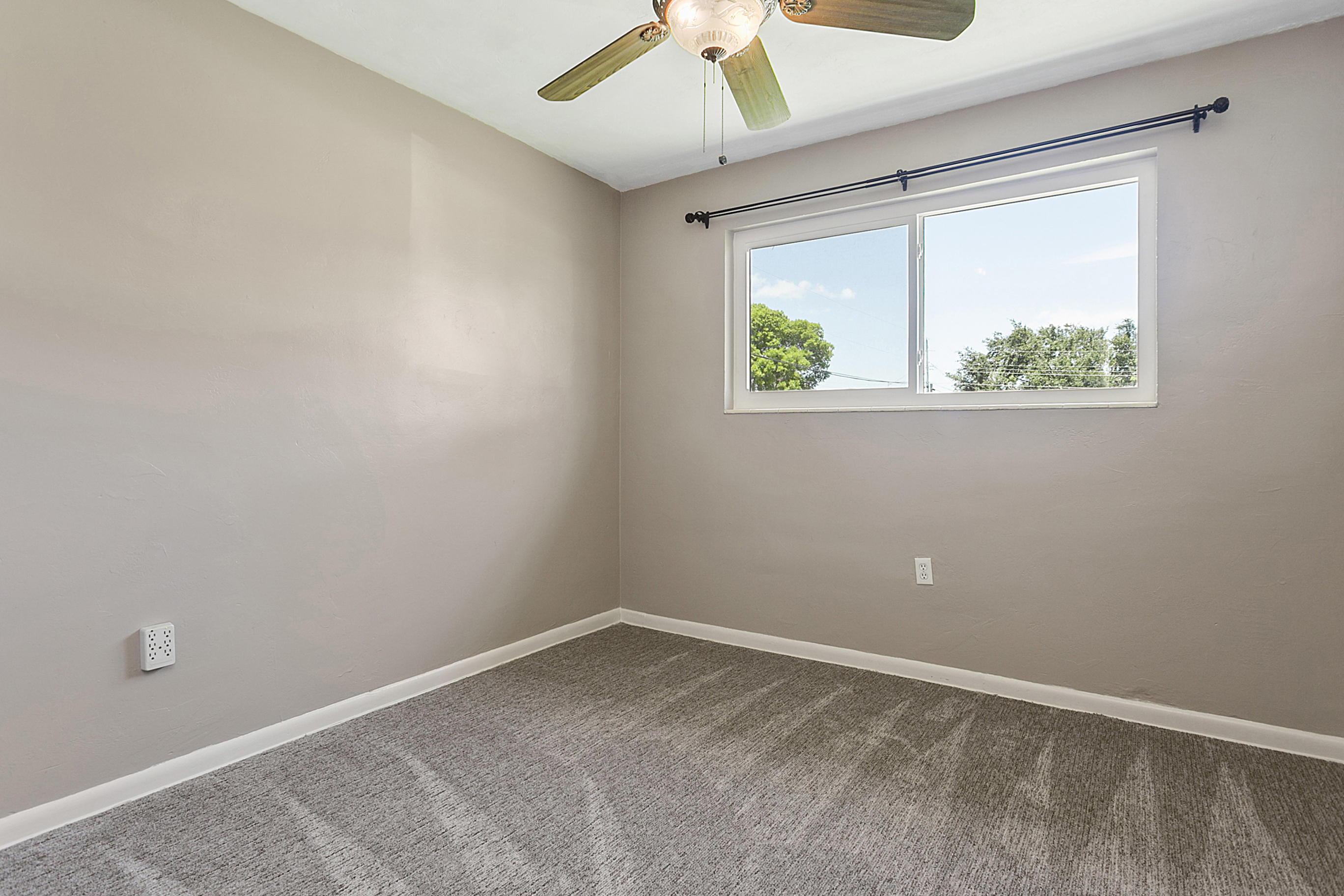 353 Shady Lane Road Palm Springs, FL 33461 - Photo 23 of 30 an empty room with a window and a ceiling fan