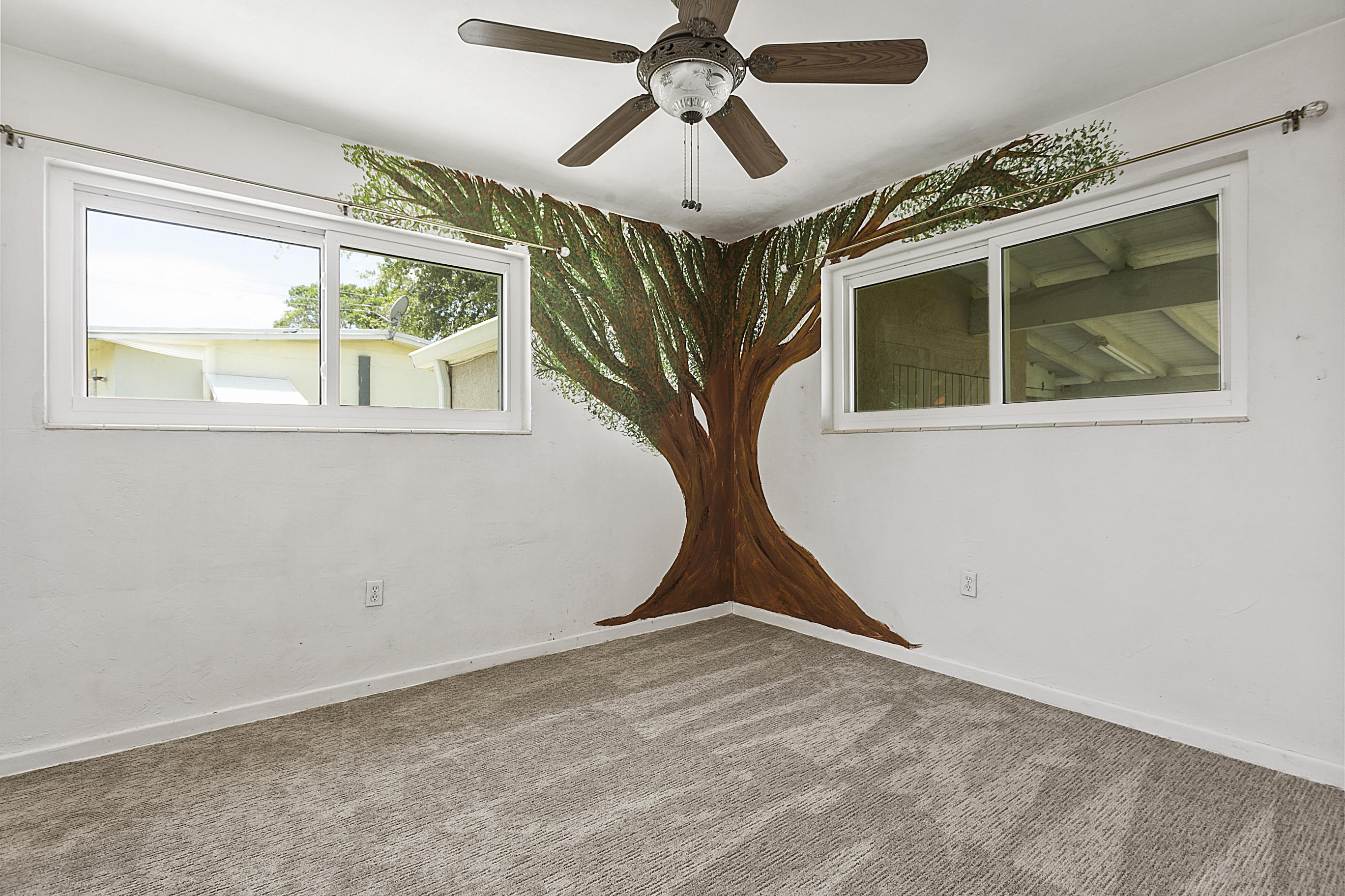 353 Shady Lane Road Palm Springs, FL 33461 - Photo 27 of 30 a view of a livingroom with a window and a ceiling fan
