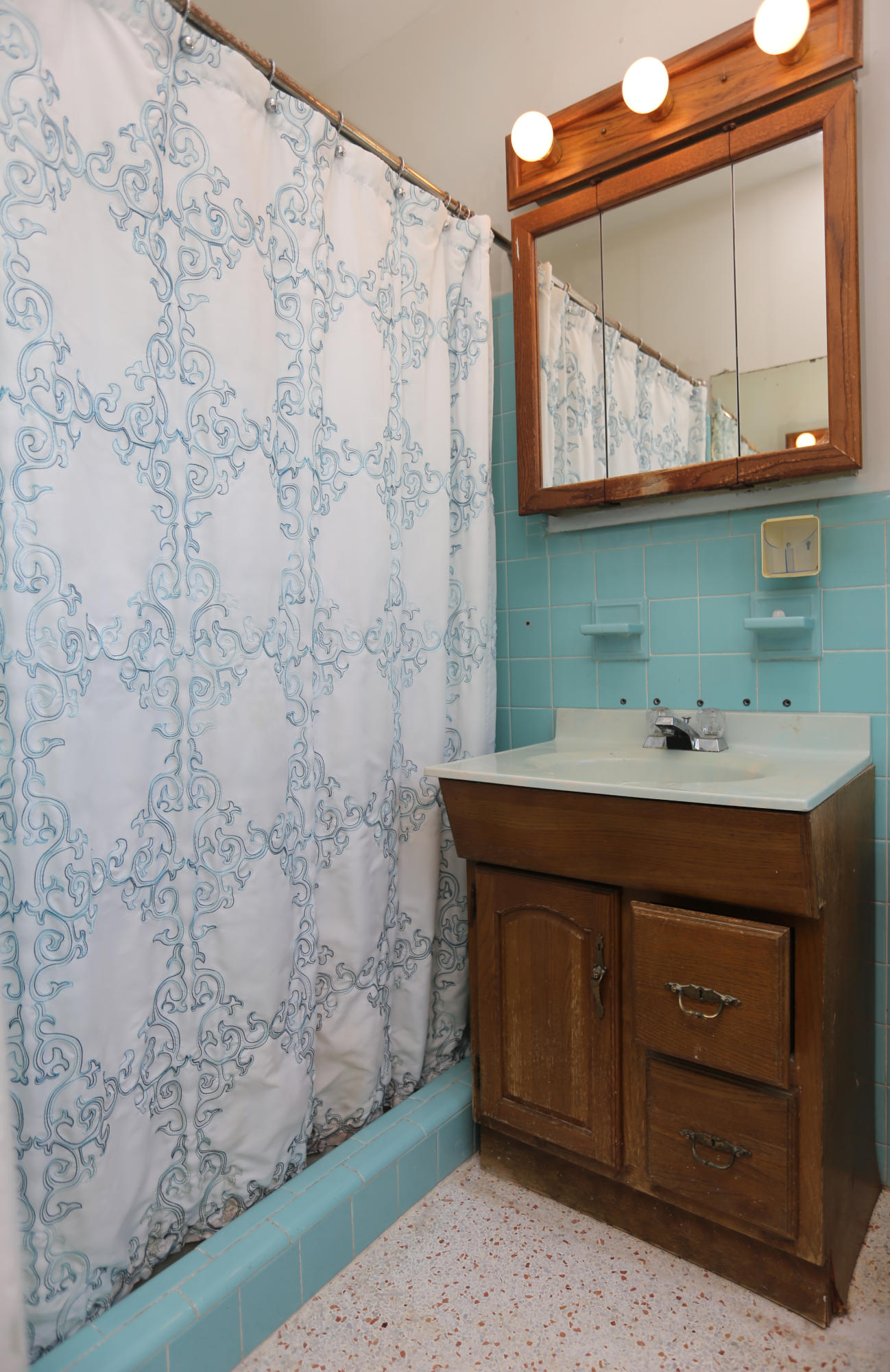353 Shady Lane Road Palm Springs, FL 33461 - Photo 30 of 30 a bathroom with a sink a mirror and a shower