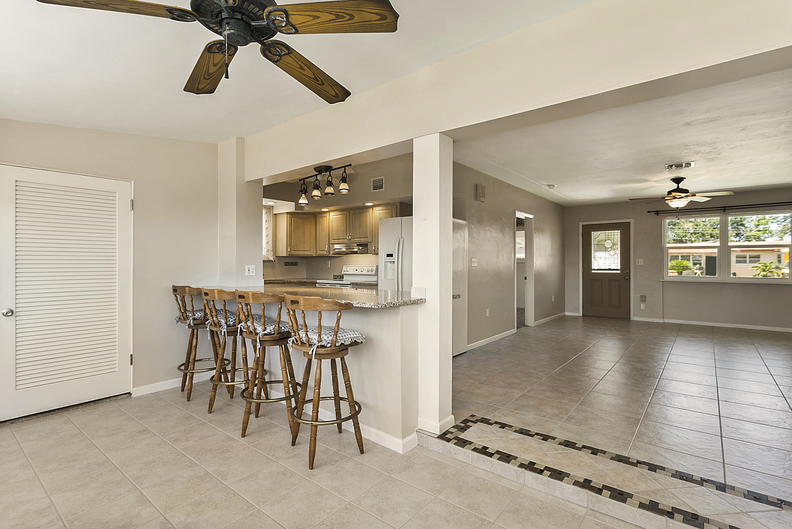 353 Shady Lane Road Palm Springs, FL 33461 - Photo 4 of 30 a view of a livingroom with furniture a ceiling fan and window