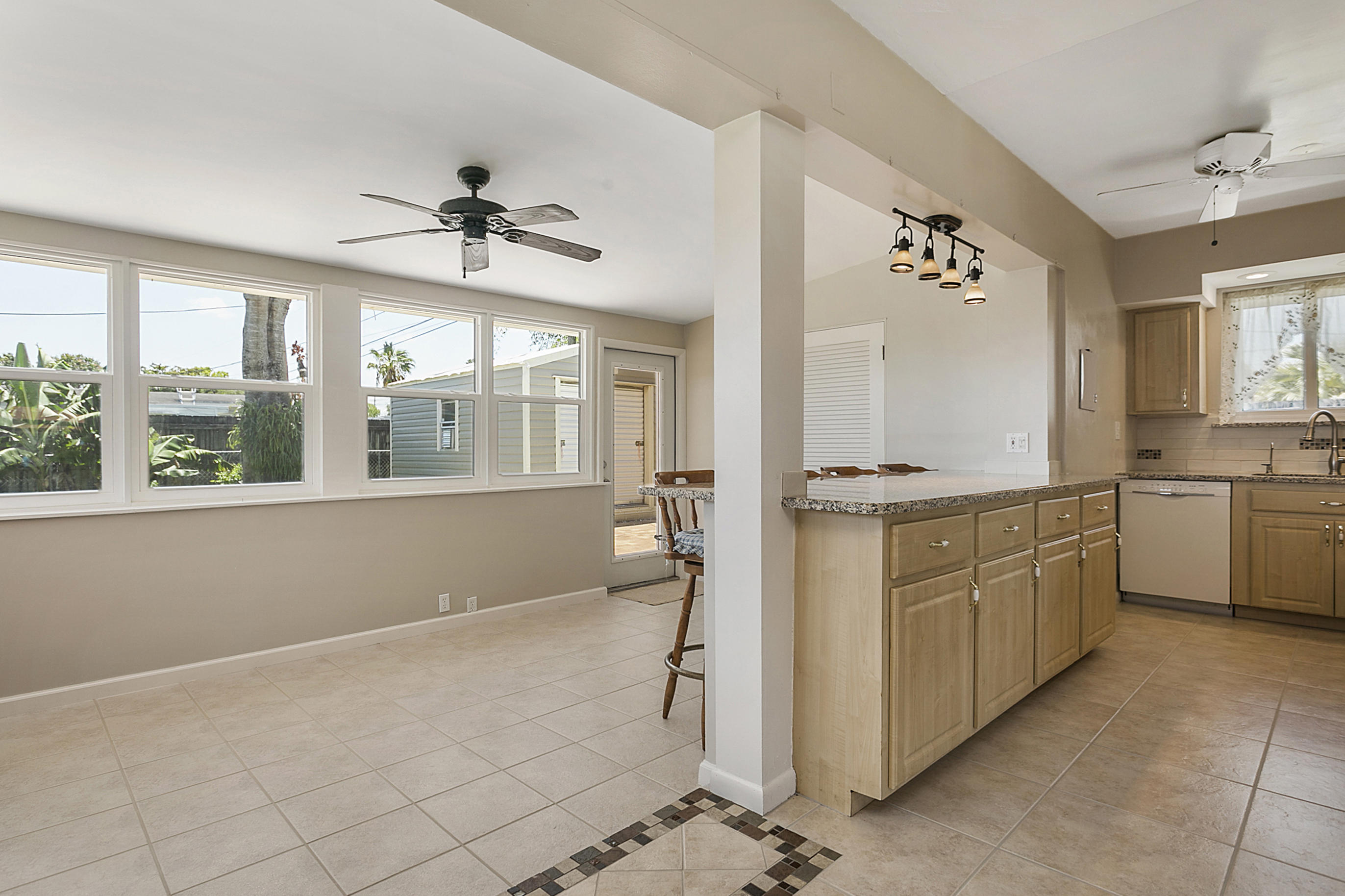353 Shady Lane Road Palm Springs, FL 33461 - Photo 8 of 30 a room with a chandelier furniture and kitchen view