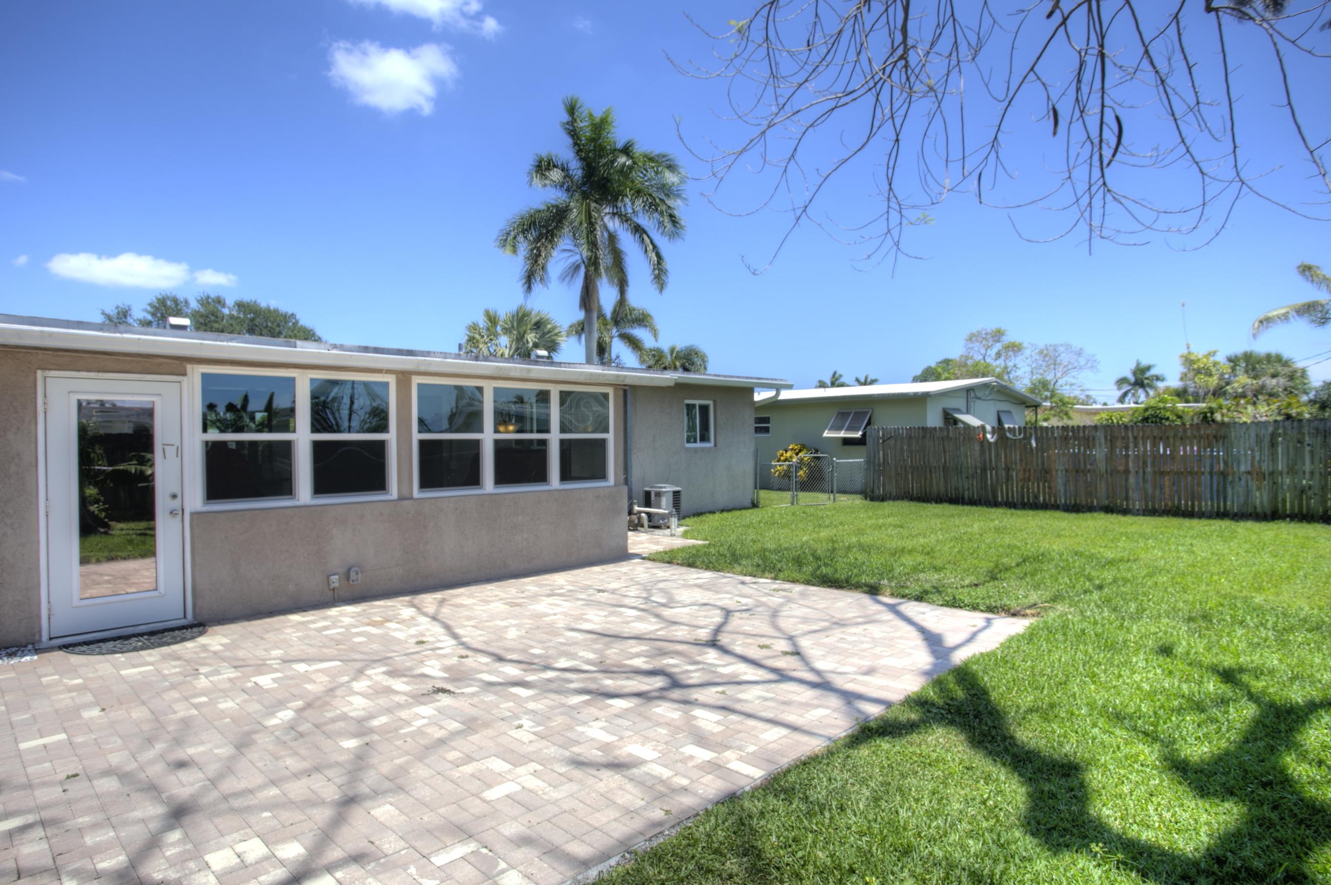 353 Shady Lane Road Palm Springs, FL 33461 - Photo 9 of 30 a front view of a house with a garden