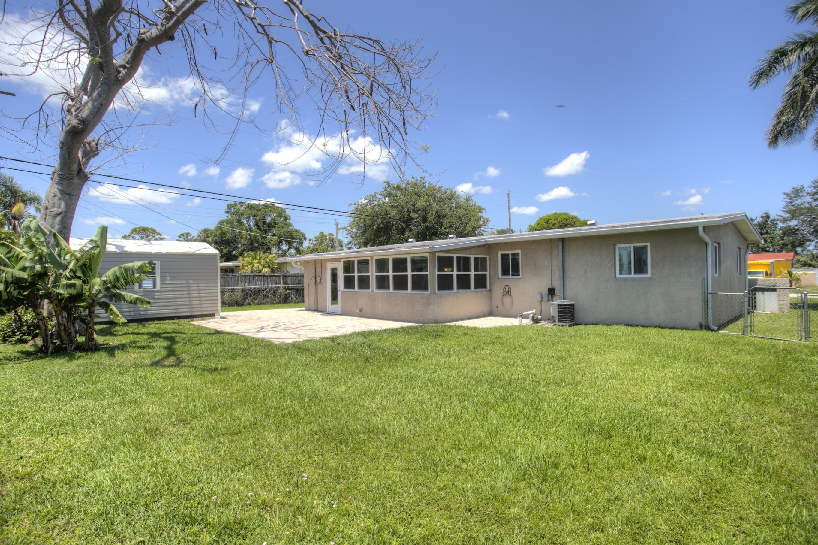 353 Shady Lane Road Palm Springs, FL 33461 - Photo 10 of 30 a view of a house with backyard and sitting area