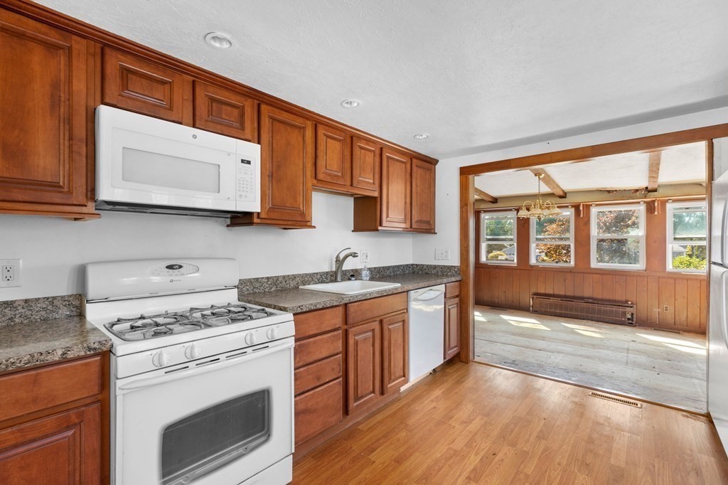 159 Arnold Road Marshfield, MA 02050 - Photo 5 of 22 a kitchen with stainless steel appliances granite countertop a stove a sink and a microwave