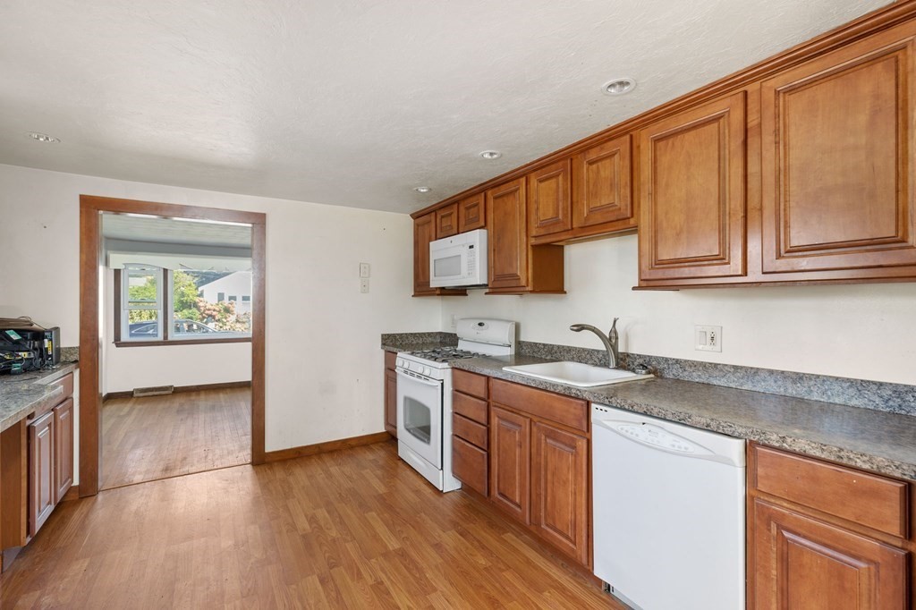 159 Arnold Road Marshfield, MA 02050 - Photo 6 of 22 a kitchen with stainless steel appliances granite countertop a sink stove and cabinets