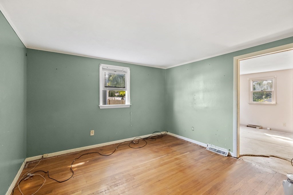159 Arnold Road Marshfield, MA 02050 - Photo 10 of 22 a view of a room with wooden floor and a window