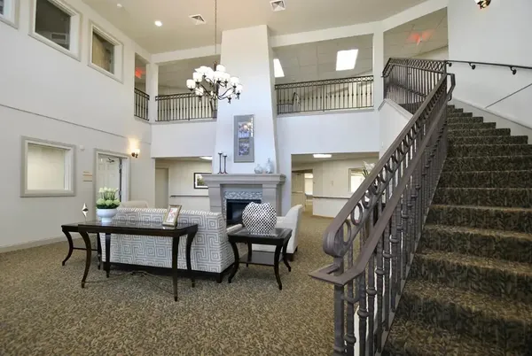 a view of hall way with furniture and stairs