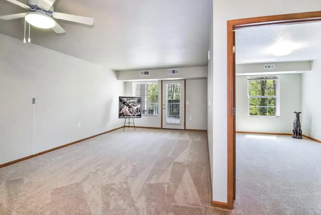 3215 West Mt Hope Avenue Lansing, MI 48911 - Photo 7 of 10 an empty room with windows and fan