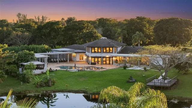 a view of a patio with a table and chairs under an umbrella