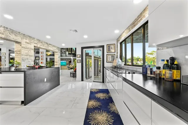 a view of a hallway with wooden floor and windows