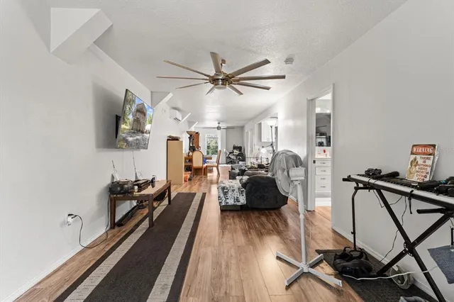 a living room with furniture a two couches and a chandelier