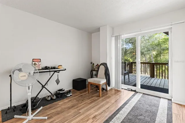a living room with furniture a rug and a wooden floor