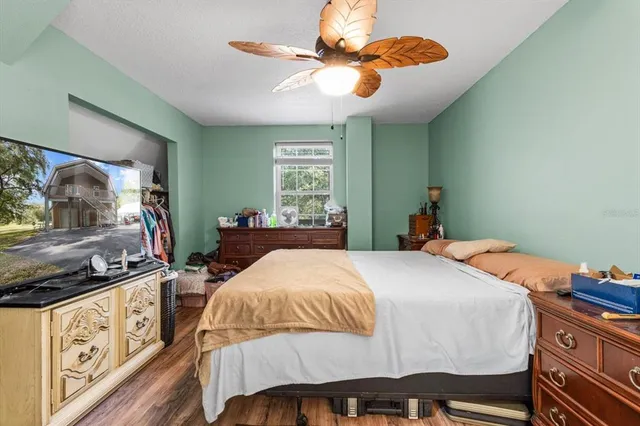 a bedroom with a bed and a chandelier