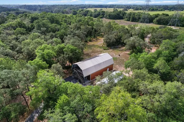 an aerial view of a house with a yard