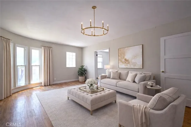 a living room with furniture chandelier and a window