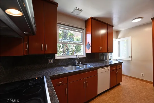 a flower garden is sitting in front of house