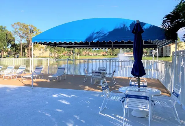 a view of a swimming pool and lounge chairs