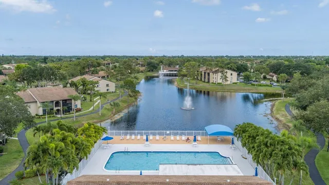 an aerial view of a house with a yard and lake view